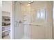 This bathroom showcases a modern glass shower with built-in shelves and bright lighting at 13093 W Cedar Dr # 121, Lakewood, CO 80228