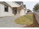 View of home and manicured lawn of a backyard that also includes a gravel area and privacy fence at 1361 Art Dr, Berthoud, CO 80513