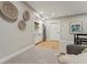 Open basement design with a wet bar, stainless steel refrigerator, and room for entertaining at 1361 Art Dr, Berthoud, CO 80513