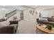 Finished basement area with multiple seating areas, stairs and wet bar at 1361 Art Dr, Berthoud, CO 80513