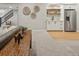 Finished basement area with carpet, wet bar, stainless refrigerator, and staircase at 1361 Art Dr, Berthoud, CO 80513