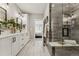 Modern bathroom with double vanity, white cabinets, and glass-enclosed shower at 1361 Art Dr, Berthoud, CO 80513