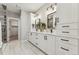 Bright bathroom with double vanity, white cabinets, and glass-enclosed shower at 1361 Art Dr, Berthoud, CO 80513