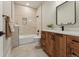 Bathroom featuring wood vanity with marble counters and a tile surround tub at 1361 Art Dr, Berthoud, CO 80513