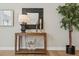 Console table decor featuring stylish mirror, lamp, candles, and wooden horse accents at 1361 Art Dr, Berthoud, CO 80513
