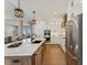 Gourmet kitchen featuring white cabinets, a stainless steel refrigerator, and a large center island at 1361 Art Dr, Berthoud, CO 80513