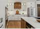 Bright kitchen featuring white cabinets, a hood vent, stainless steel appliances, and marble countertops at 1361 Art Dr, Berthoud, CO 80513