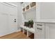 Mudroom boasting storage bench with built-in shelving for organized functionality at 1361 Art Dr, Berthoud, CO 80513