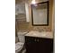Bathroom featuring a vanity, dark wood cabinet, mirror, and neutral walls at 5171 S Quintero St, Centennial, CO 80015