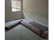 Bright bedroom featuring a window and remnants of old carpet, awaiting new flooring at 5171 S Quintero St, Centennial, CO 80015