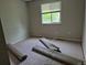 Bedroom with neutral walls, a window offering natural light, and removed carpet ready for updates at 5171 S Quintero St, Centennial, CO 80015