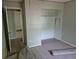 Bedroom with an open closet and doorway shows the space with carpet removed, ready for renovation at 5171 S Quintero St, Centennial, CO 80015