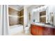 Well-appointed bathroom with bathtub, shower, and vanity with wood cabinetry at 8041 E 29Th Ave, Denver, CO 80238