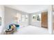 Spacious bedroom filled with natural light, complemented by a comfortable seating area at 8041 E 29Th Ave, Denver, CO 80238