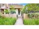 Charming front entrance with a walkway leading to the front door, surrounded by lush landscaping at 8041 E 29Th Ave, Denver, CO 80238