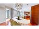 A chef's kitchen and eat-in dining space are filled with natural light from glass patio doors at 8041 E 29Th Ave, Denver, CO 80238