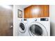 Convenient laundry room featuring a modern washer and dryer and ample storage space at 8041 E 29Th Ave, Denver, CO 80238