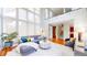 Bright living room features soaring ceilings, large windows, modern furnishings and hardwood floors at 8041 E 29Th Ave, Denver, CO 80238
