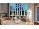 Bright living room with floor-to-ceiling windows and a cozy fireplace at 8041 E 29Th Ave, Denver, CO 80238