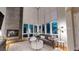 Bright living room with floor-to-ceiling windows and a cozy fireplace at 8041 E 29Th Ave, Denver, CO 80238