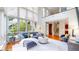 Bright living room features soaring ceilings, large windows, modern furnishings and hardwood floors at 8041 E 29Th Ave, Denver, CO 80238