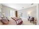This primary bedroom features a walk-out balcony, sitting area, and ample natural light at 8041 E 29Th Ave, Denver, CO 80238