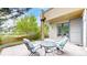 Charming outdoor patio area features comfortable seating, a small table, and garden views at 8041 E 29Th Ave, Denver, CO 80238