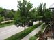Street view of the modern home with mature trees and a well-maintained lawn at 8041 E 29Th Ave, Denver, CO 80238
