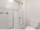 Bathroom featuring a shower with glass doors and a low-flow toilet at 9725 E Harvard Ave # 317, Denver, CO 80231