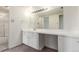 Bathroom features a vanity with storage and a large mirror at 9725 E Harvard Ave # 317, Denver, CO 80231