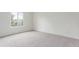 Bedroom with carpet floors, white walls and a large picture window at 9725 E Harvard Ave # 317, Denver, CO 80231