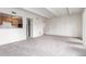 Neutral-carpeted living room open to kitchen with a passthrough at 9725 E Harvard Ave # 317, Denver, CO 80231