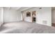 Open floor plan living room with neutral carpeting and passthrough to kitchen at 9725 E Harvard Ave # 317, Denver, CO 80231