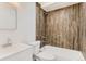 Updated bathroom with wood-look tile and a bathtub at 1445 Yosemite St # 12, Denver, CO 80220