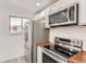 Stainless steel appliances and wood countertops in this kitchen at 1445 Yosemite St # 12, Denver, CO 80220