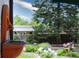 Tranquil backyard view showcasing a water fountain and flowering plants at 7121 E Arkansas Ave, Denver, CO 80224
