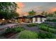 Private backyard oasis with a spacious deck, outdoor seating, a lush garden, and mature trees at 7121 E Arkansas Ave, Denver, CO 80224