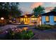 Landscaped backyard with deck, patio furniture and mature plantings at 7121 E Arkansas Ave, Denver, CO 80224