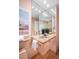 Bathroom with sink, mirror, and view of tub shower combo at 7121 E Arkansas Ave, Denver, CO 80224