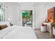 Sun-filled bedroom with a desk and decor, opening to a patio with umbrella-covered table at 7121 E Arkansas Ave, Denver, CO 80224