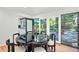 Dining area with black table, backyard views and access to kitchen for seamless dining at 7121 E Arkansas Ave, Denver, CO 80224