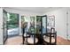Dining area with black table and chairs plus access to spacious backyard with patio at 7121 E Arkansas Ave, Denver, CO 80224