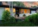 Inviting single-story home with white brick exterior, charming front porch, and lush landscaping at 7121 E Arkansas Ave, Denver, CO 80224