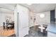 Kitchen featuring white appliances, dark tile floors, breakfast table and view to dining area at 7121 E Arkansas Ave, Denver, CO 80224