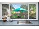 Kitchen sink featuring stainless steel sink, faucet, and a window view of lush outdoor garden at 7121 E Arkansas Ave, Denver, CO 80224