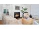 Cozy living room with a warm fireplace, comfortable seating, and stylish decor at 7121 E Arkansas Ave, Denver, CO 80224