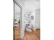 Bright room featuring built-in desk area and a view into the bedroom and outdoor space at 7121 E Arkansas Ave, Denver, CO 80224