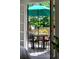 Patio view with table, chairs, and an umbrella, seen through an open door at 7121 E Arkansas Ave, Denver, CO 80224