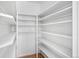Walk-in closet with wooden floor and multiple shelves for organization and storage at 7121 E Arkansas Ave, Denver, CO 80224
