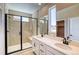Modern bathroom featuring a walk-in shower, dual sink vanity, and contemporary finishes at 8633 Middle Fork St, Littleton, CO 80125
